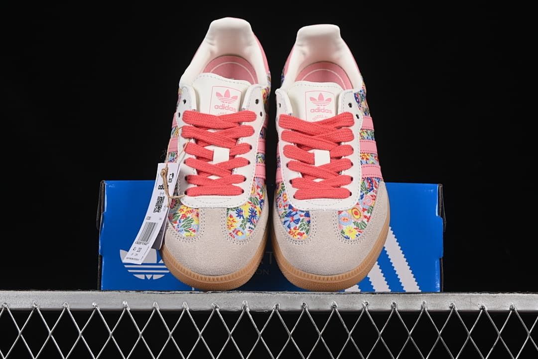Front view of both floral sneakers on the blue box.