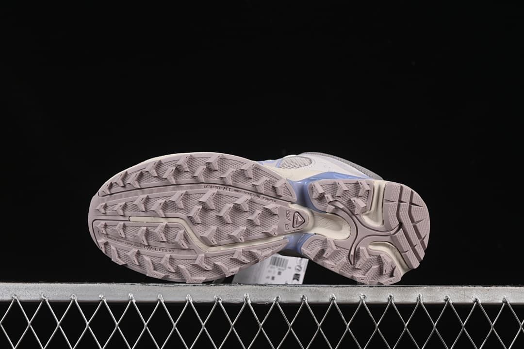 Underside view showing the patterned lugged outsoles.