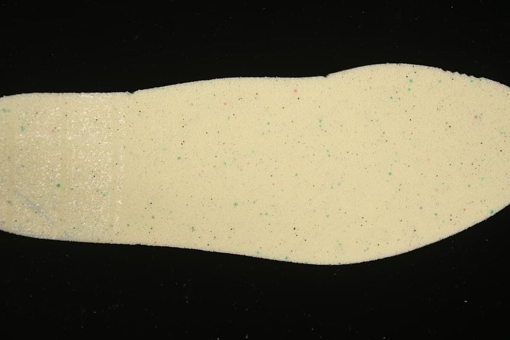 Close-up of a speckled light-colored shoe component