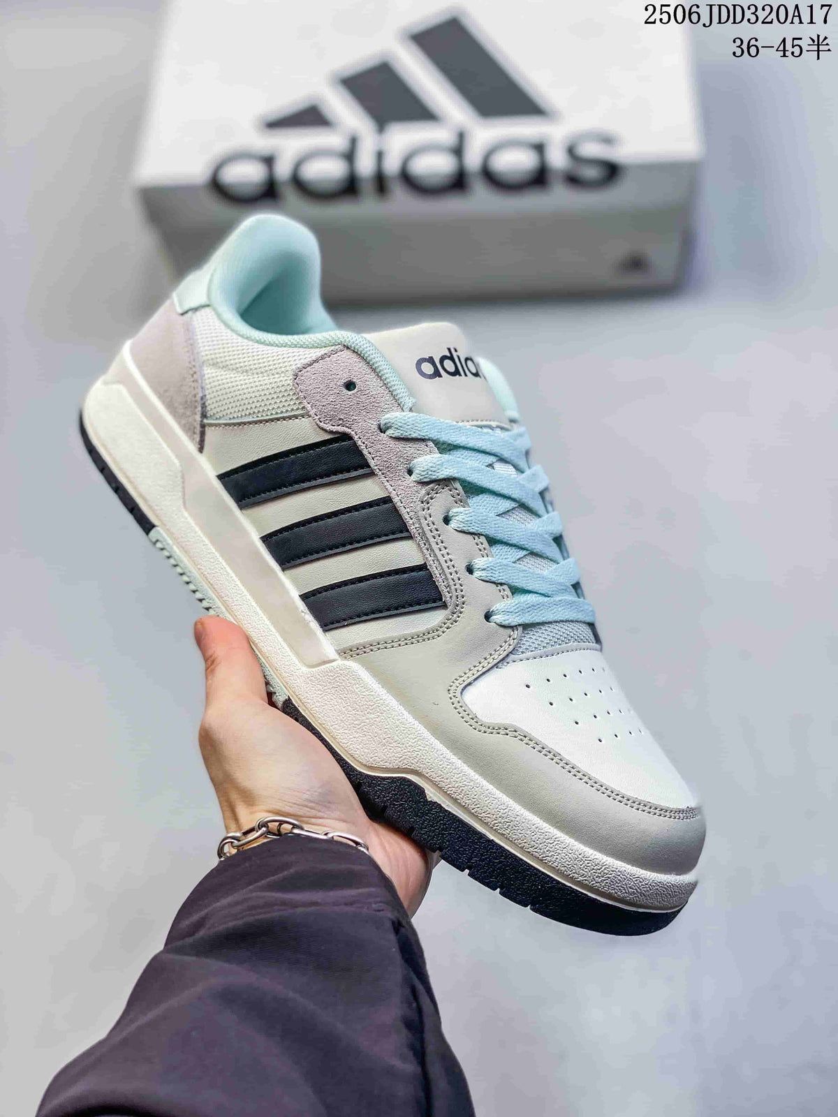White adidas Entrap sneaker with black side stripes, pale blue lining, and a dark outsole