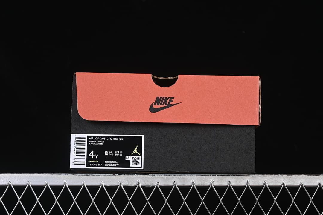 Shoebox label identifying the pictured pair as Air Jordan 12 Retro GS, White/Black-Taxi, size 4Y.