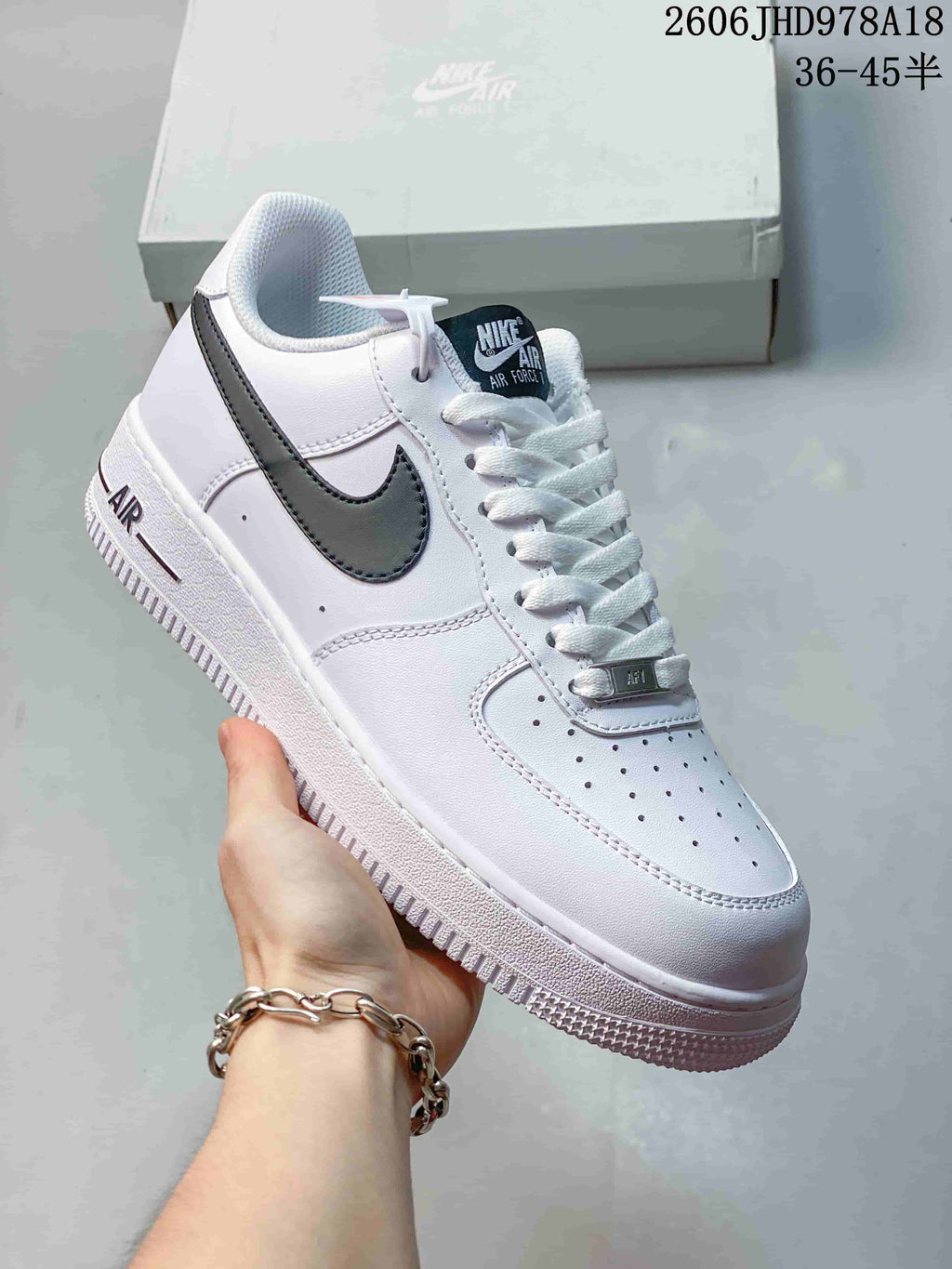 Angled side view of a white Nike Air Force 1 sneaker with black Swoosh accents