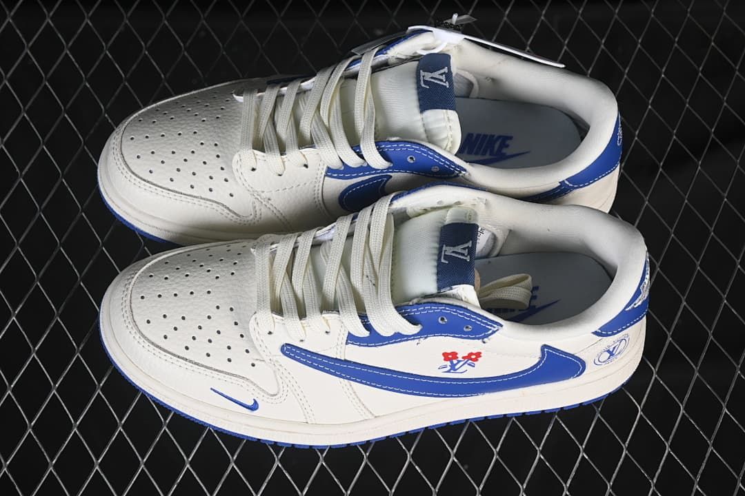 Overhead view of a pair of white and blue low-top sneakers with floral-style details