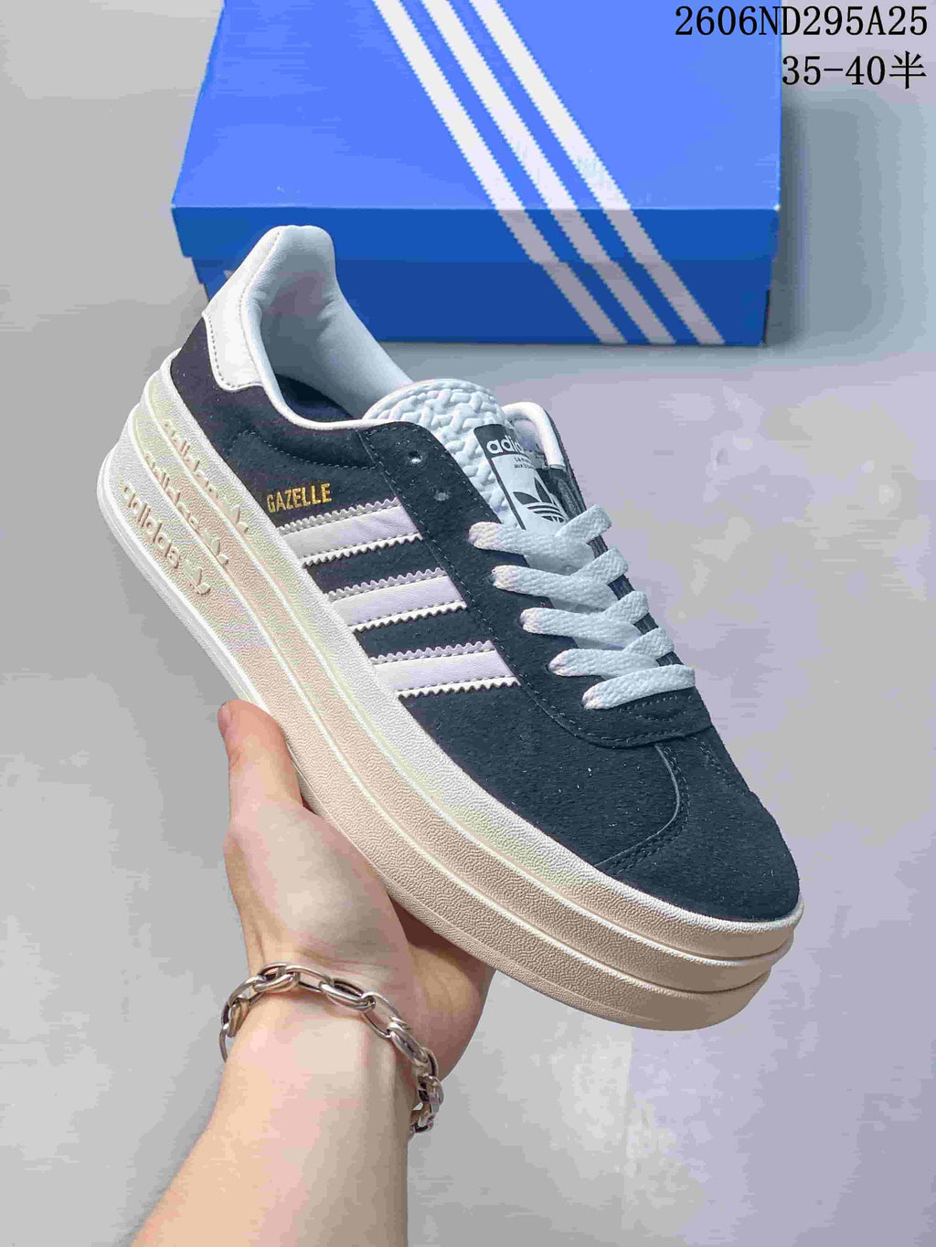Navy low-top sneaker with pale stripes, light laces, and a light-colored raised sole.