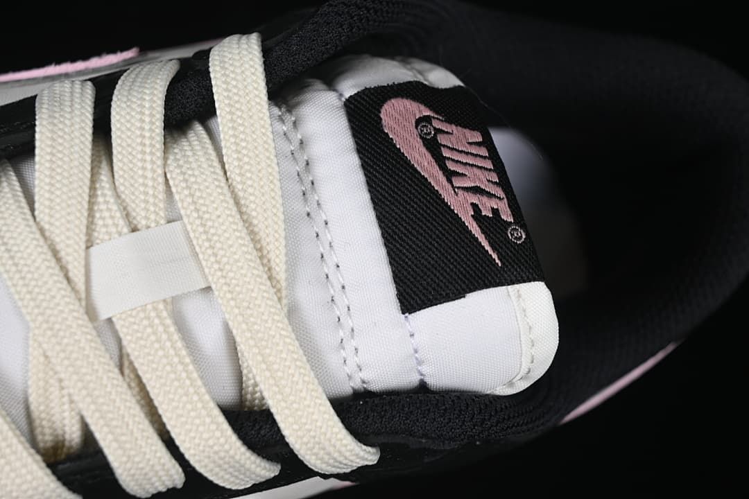Close-up of cream-colored laces and tongue branding