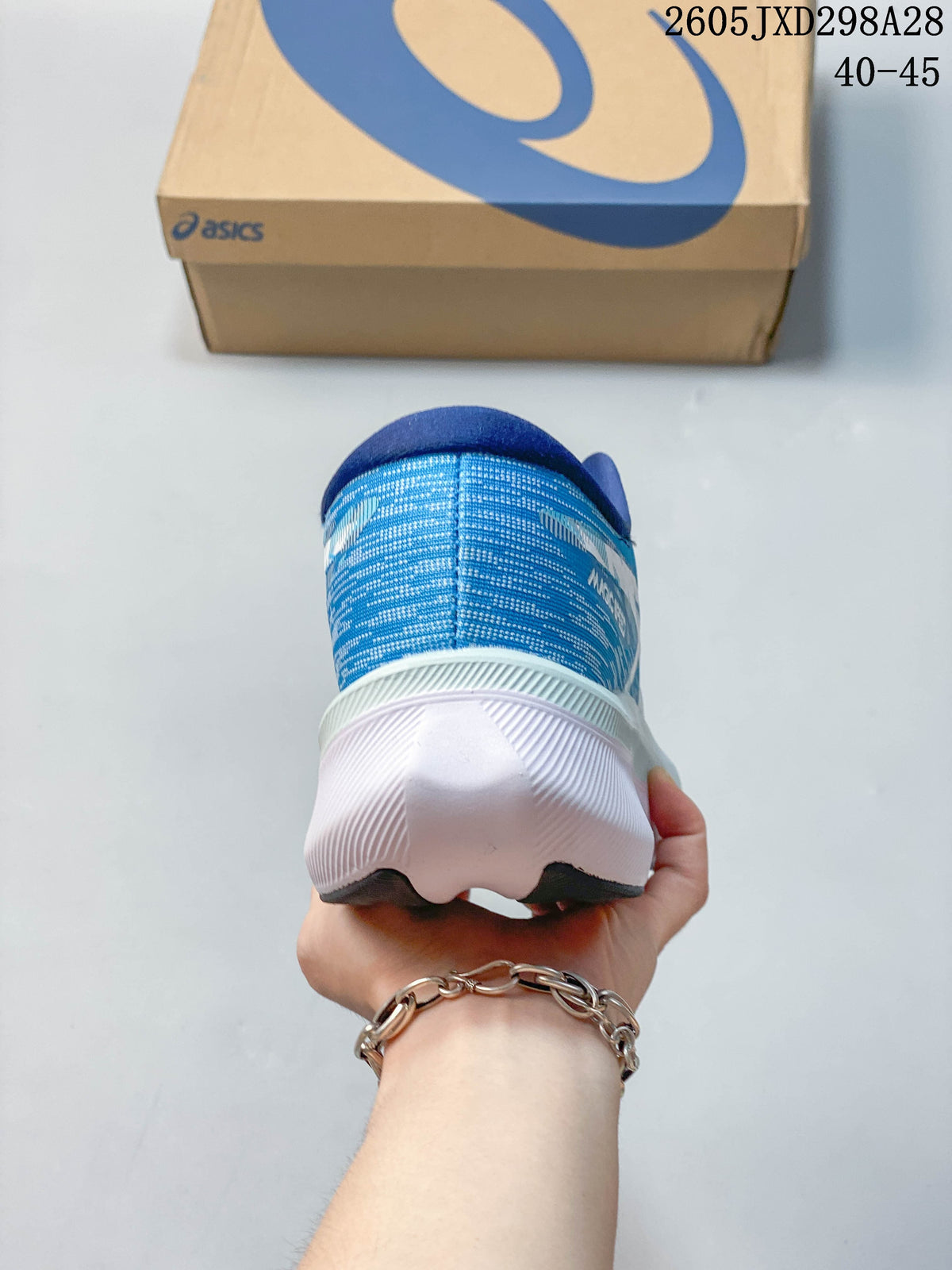 Rear view of a blue ASICS Magic Speed 4 shoe