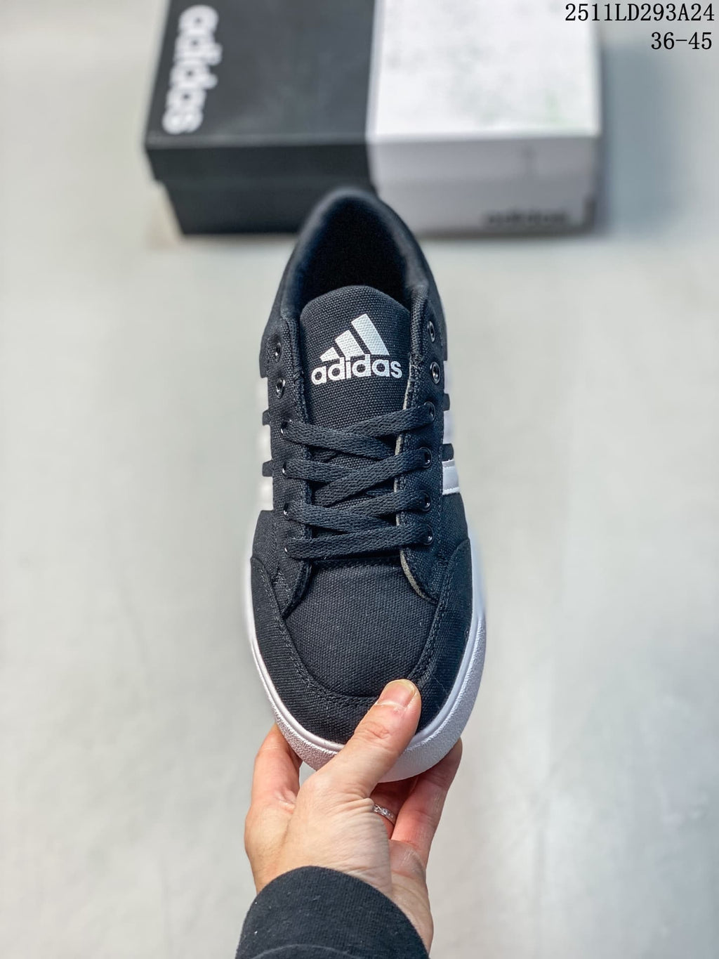 Front view of the navy lace-up sneaker with white tongue branding.