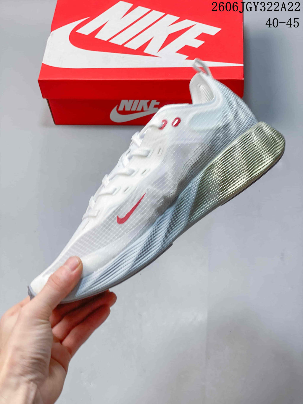Side view of the white Nike Ava X sneaker with red accents and sculpted heel.