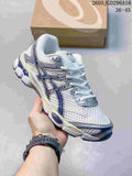 White ASICS Gel-Cumulus 16 sneaker with navy accents, shown beside a shoebox.