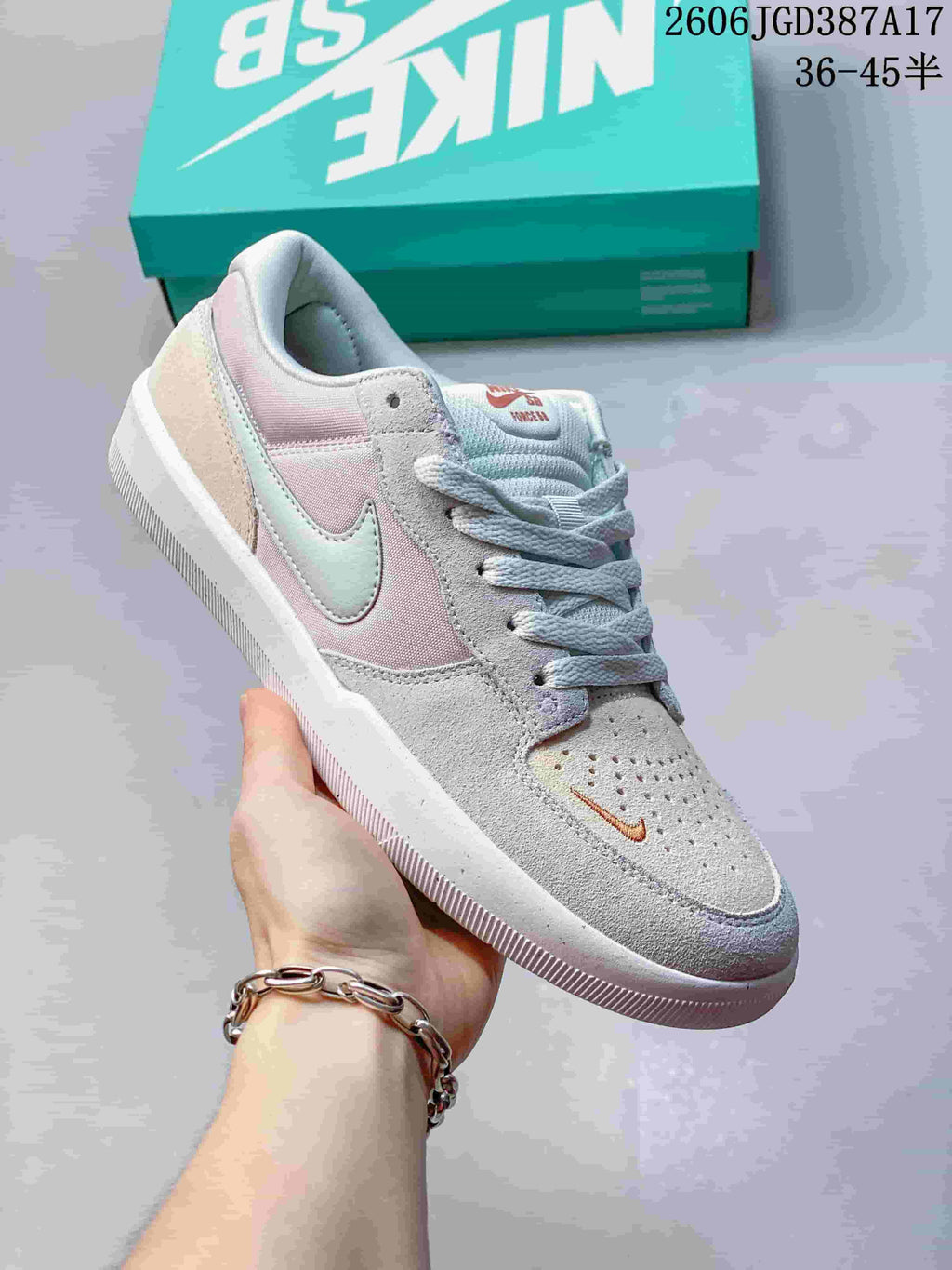 Angled side view highlighting pastel panels, suede-like texture, and small toe Swoosh