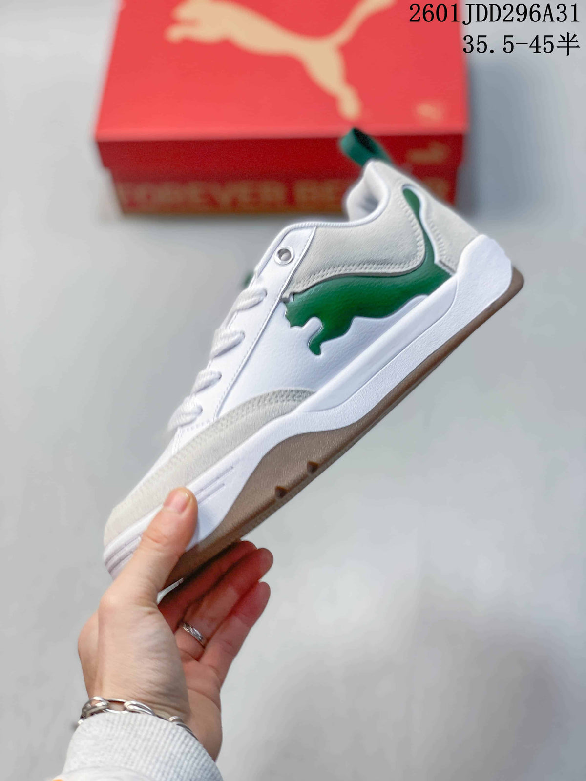Side view of the white sneaker with green side detailing and gum-tone outsole