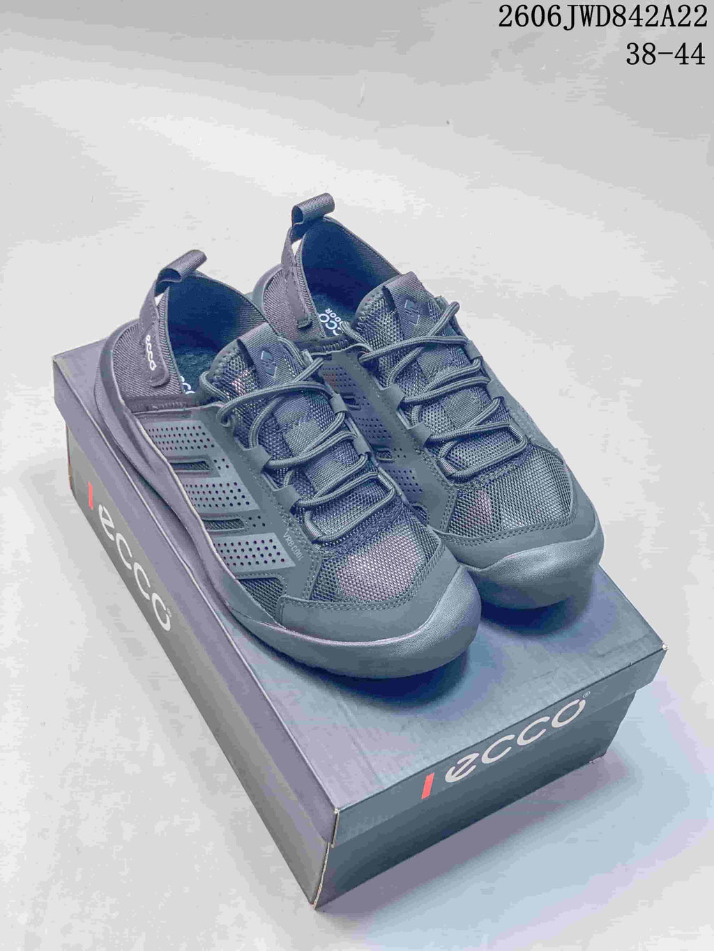 Pair of dark gray ECCO lace-up sneakers shown on a branded box