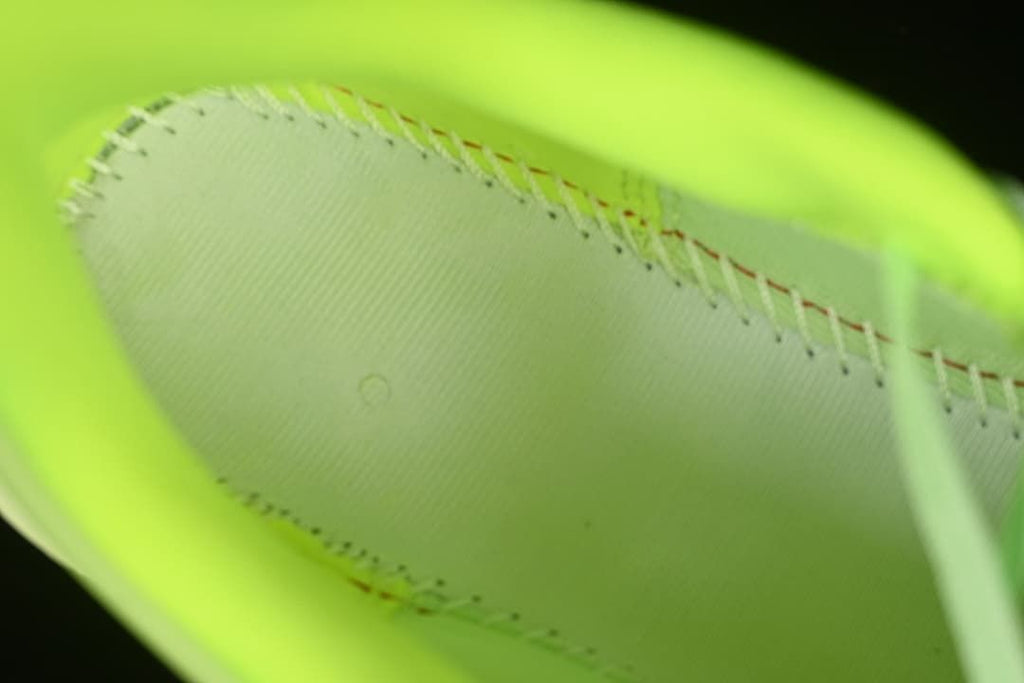 Interior close-up showing stitching and the bright green lining.