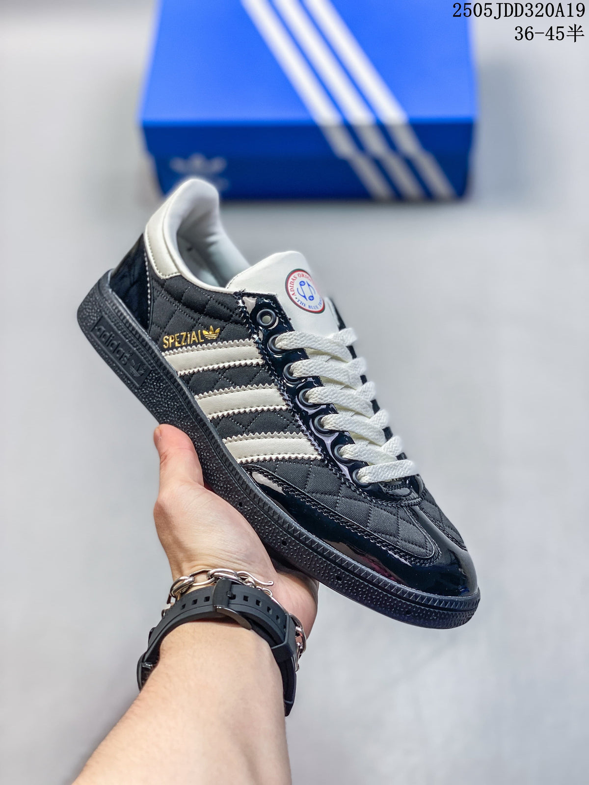 Angled view highlighting the dark upper, white stripes, cream laces, and glossy overlays.