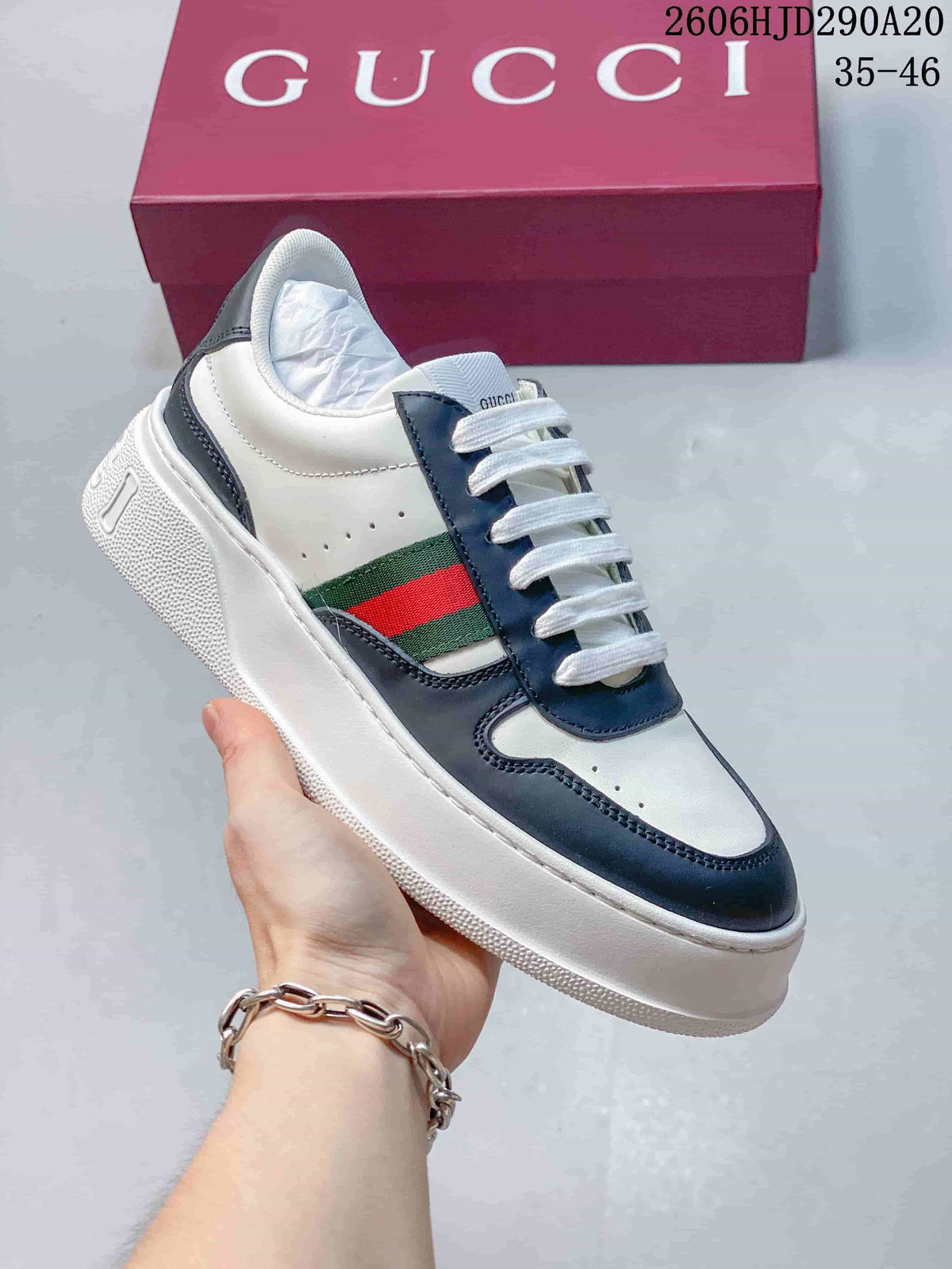 Angled view of a white and navy low-top sneaker with a chunky sole