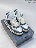 Pair of white and dark-panel Jordan 4 sneakers shown on a shoe box