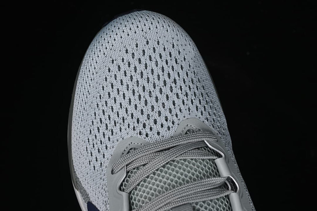 Top view of the perforated-looking light gray toe and laces