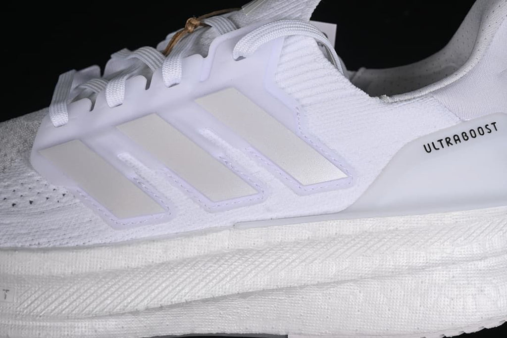 Close-up of the side stripes, upper, laces, and midsole.