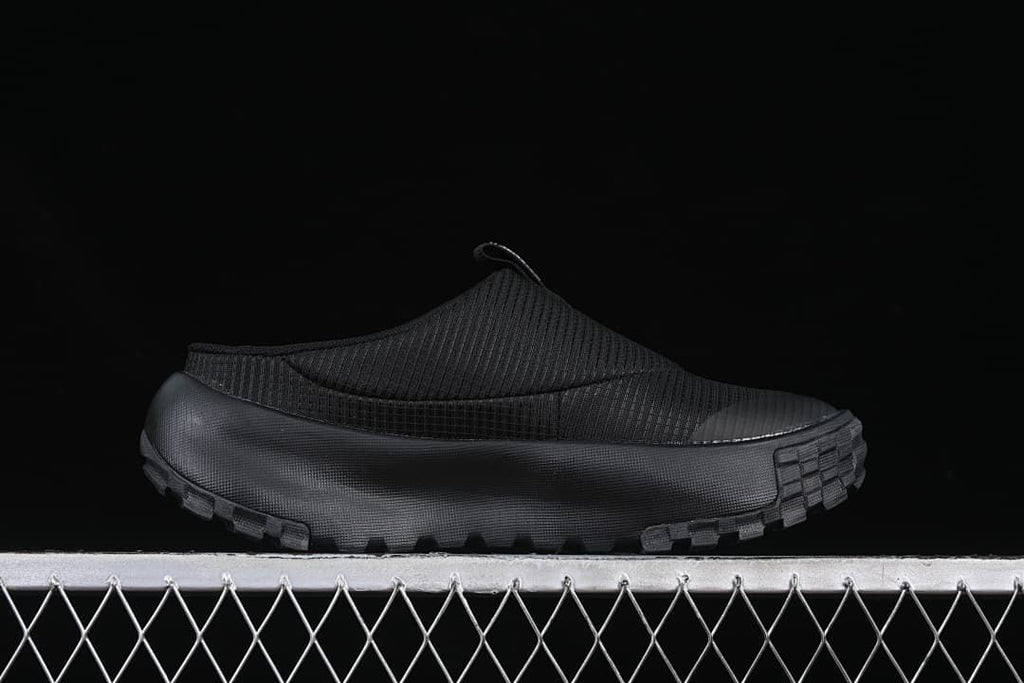 Side profile of the black mule and chunky outsole