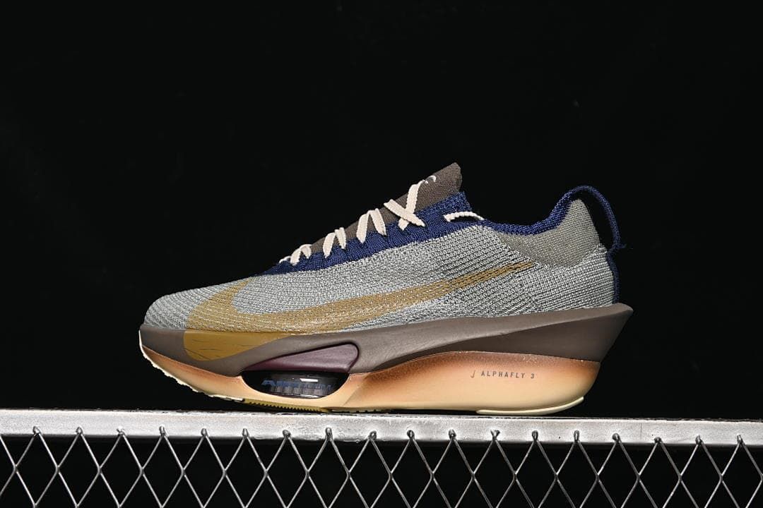 Side view of the silver-toned Nike Alphafly 3 with gold-colored accents