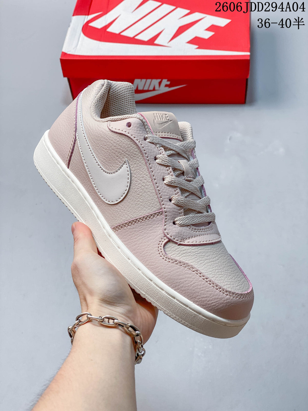 Angled view of the pale pink and off-white low-top sneaker with a side Swoosh.