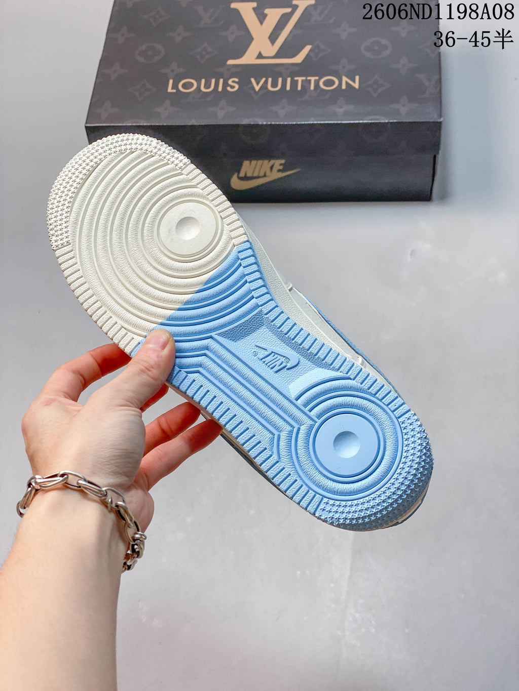 Close-up of the sneaker outsole with cream and light blue sections