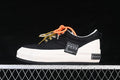 Side view of black low-top sneakers with a white platform sole and multicolor laces