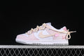 Side view of pale pink and white Nike SB Dunk Low sneakers with cream laces
