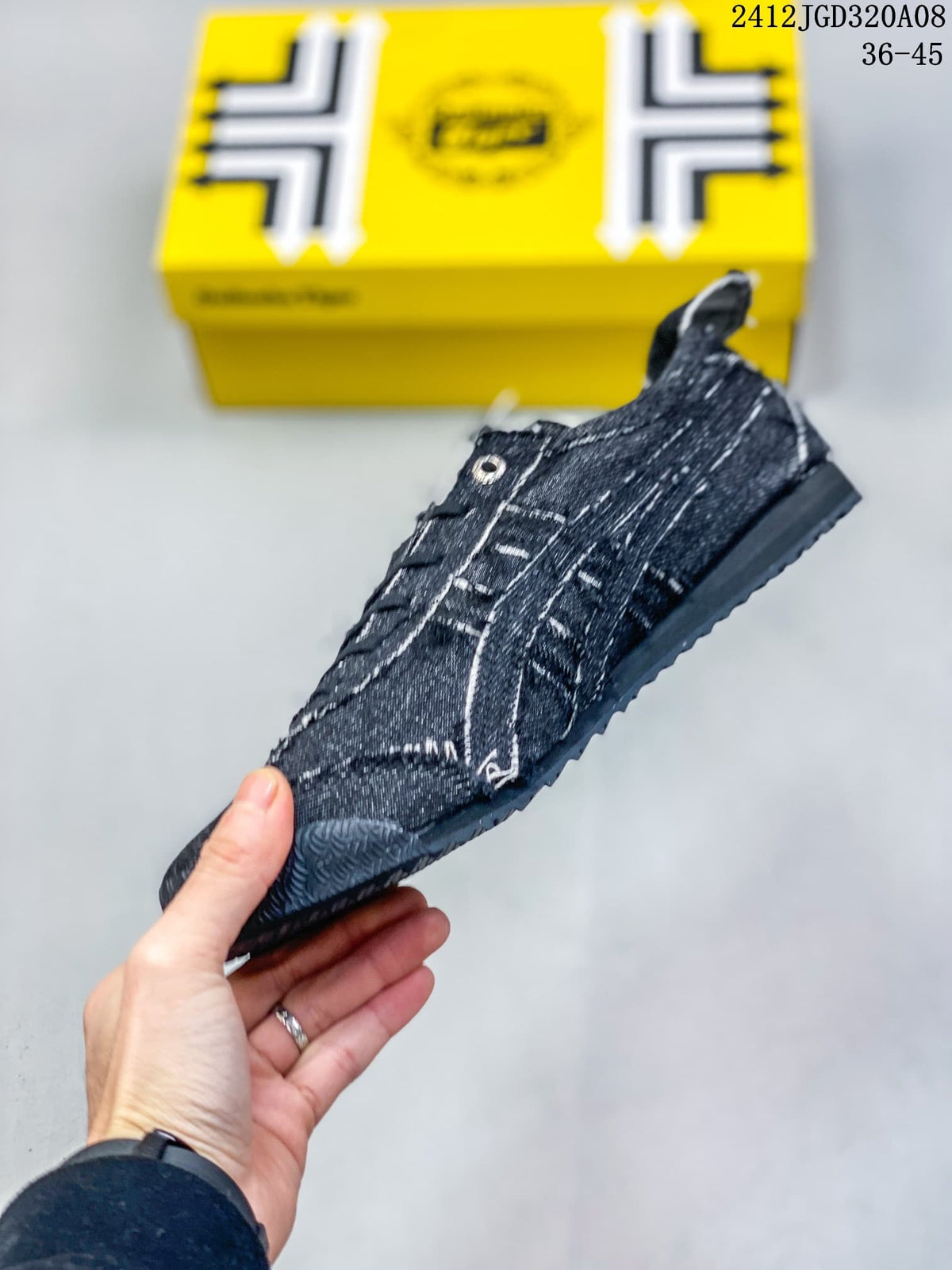 Side view of the dark denim-style low-top sneaker