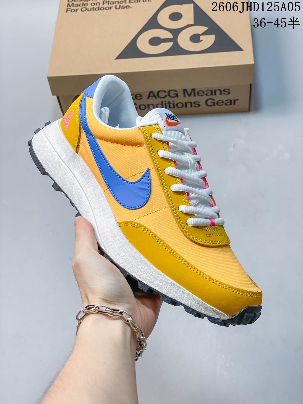Side view of yellow and blue Nike ACG LDV sneaker with a lugged outsole
