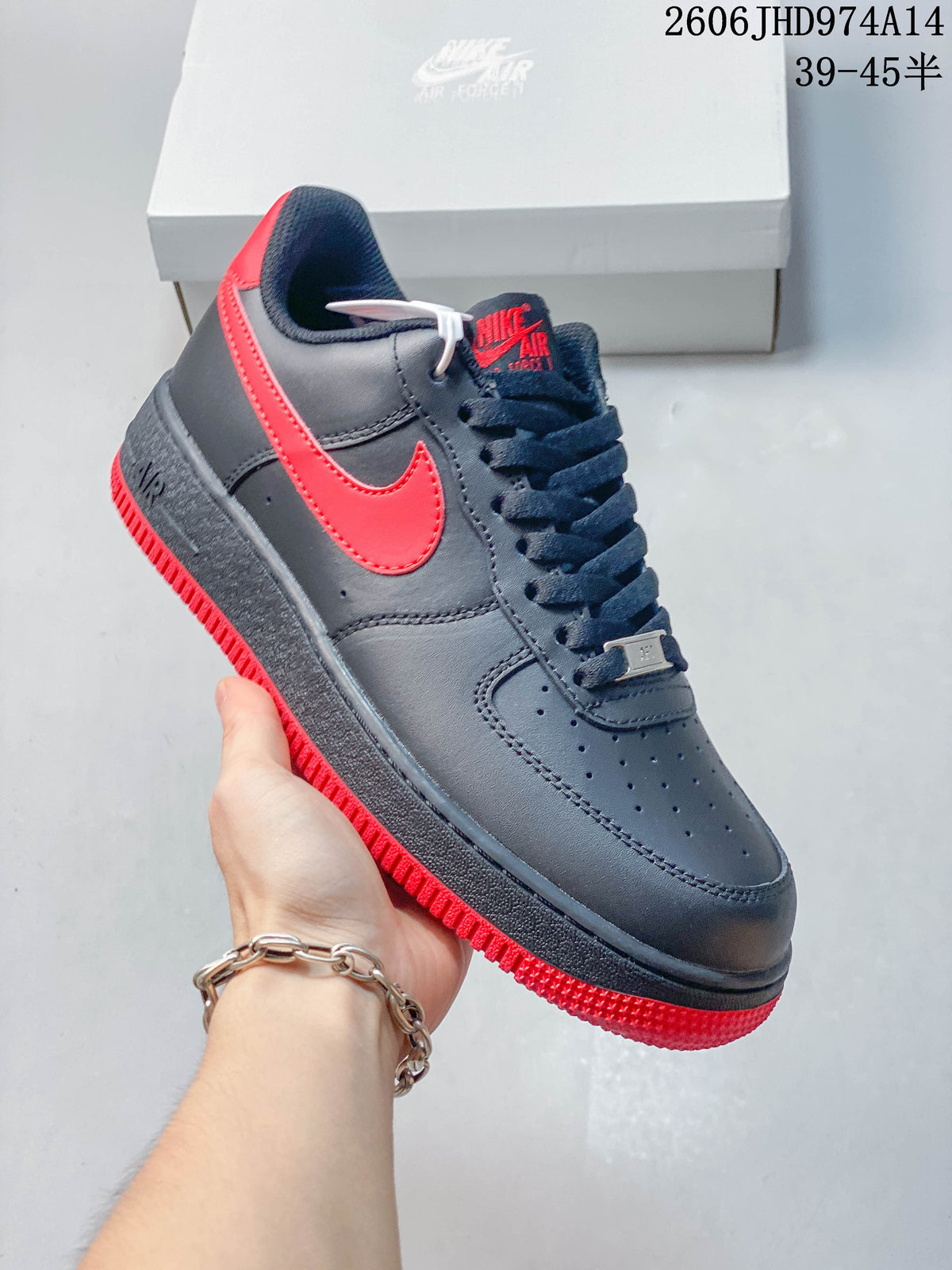 Angled side view of a navy low-top sneaker with red accents