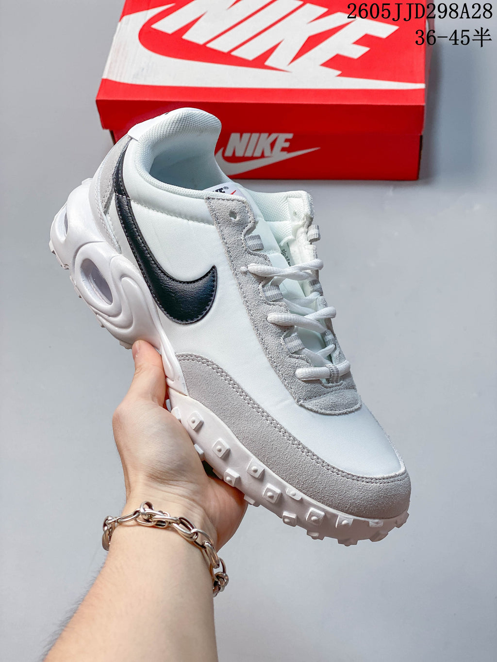 White and gray Nike Air Max Waffle SP low-top sneaker with a black side Swoosh.