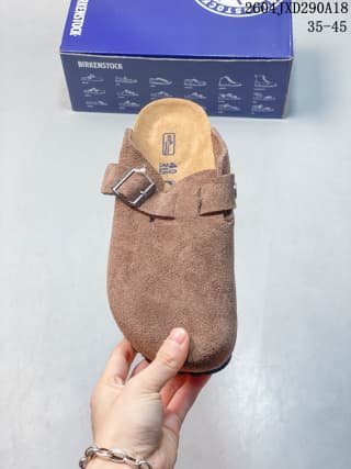 Top view of a brown closed-toe clog with an adjustable buckle strap and branded footbed.