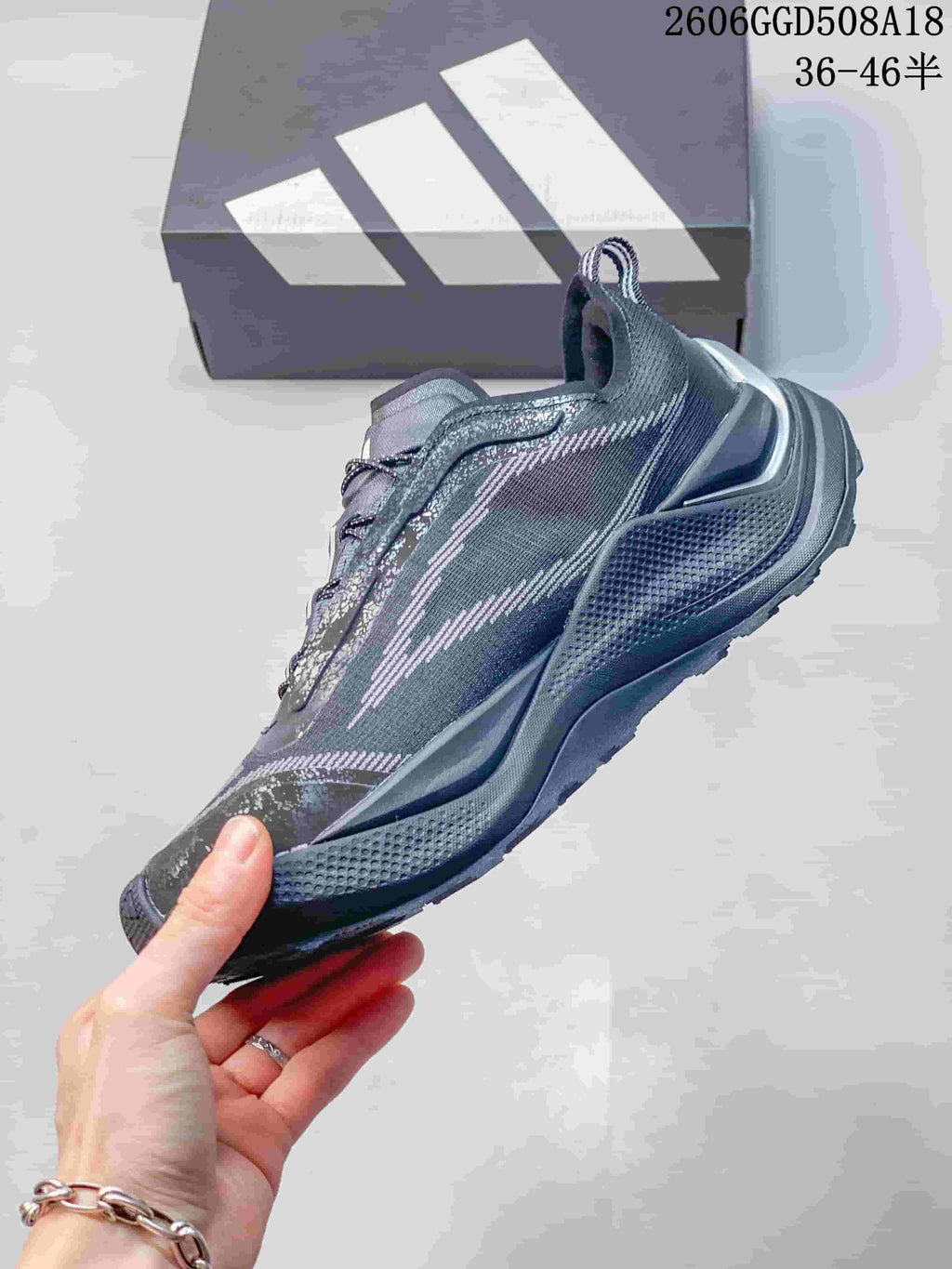 Side view of a gray low-top trail running shoe