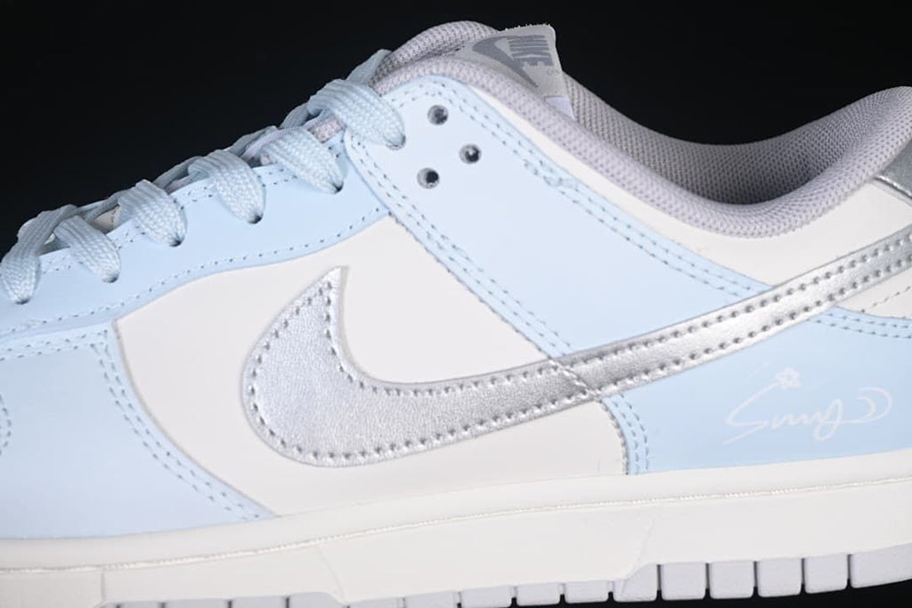 Close-up of silver Swoosh, light blue overlays, and side detail