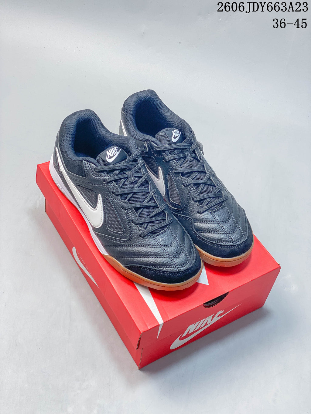 Pair of dark gray Nike Gato low-top sneakers with white side accents