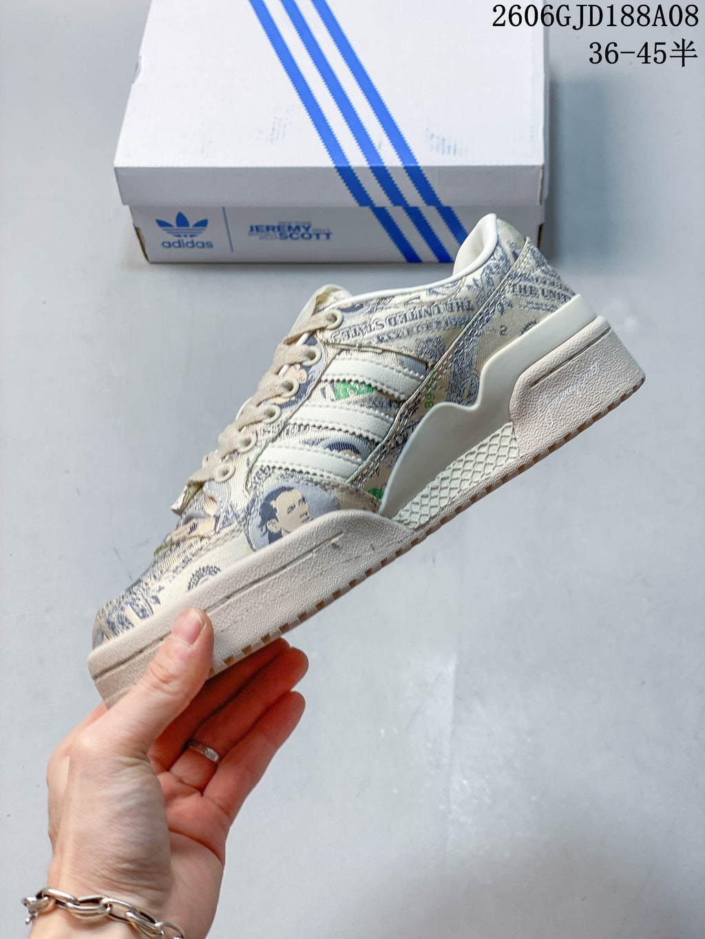 Side profile showing the banknote print, adidas stripes and wing-shaped decorative detail