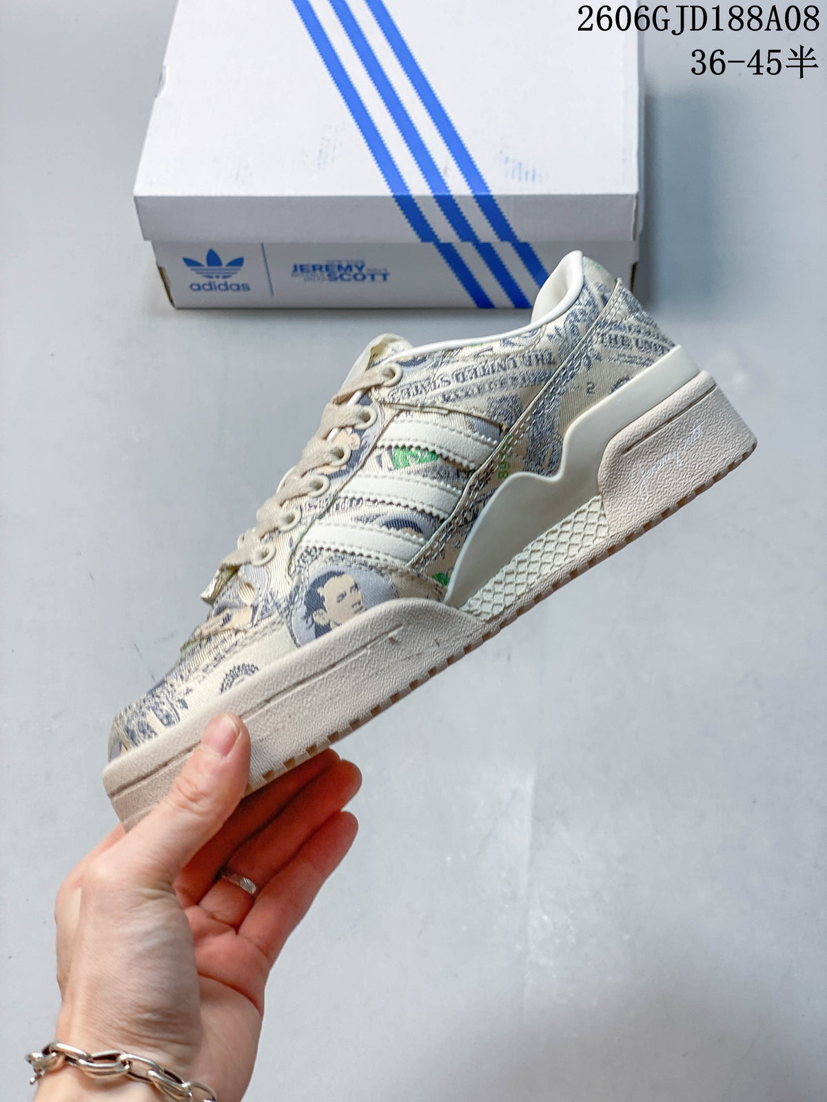 Side profile showing the banknote print, adidas stripes and wing-shaped decorative detail