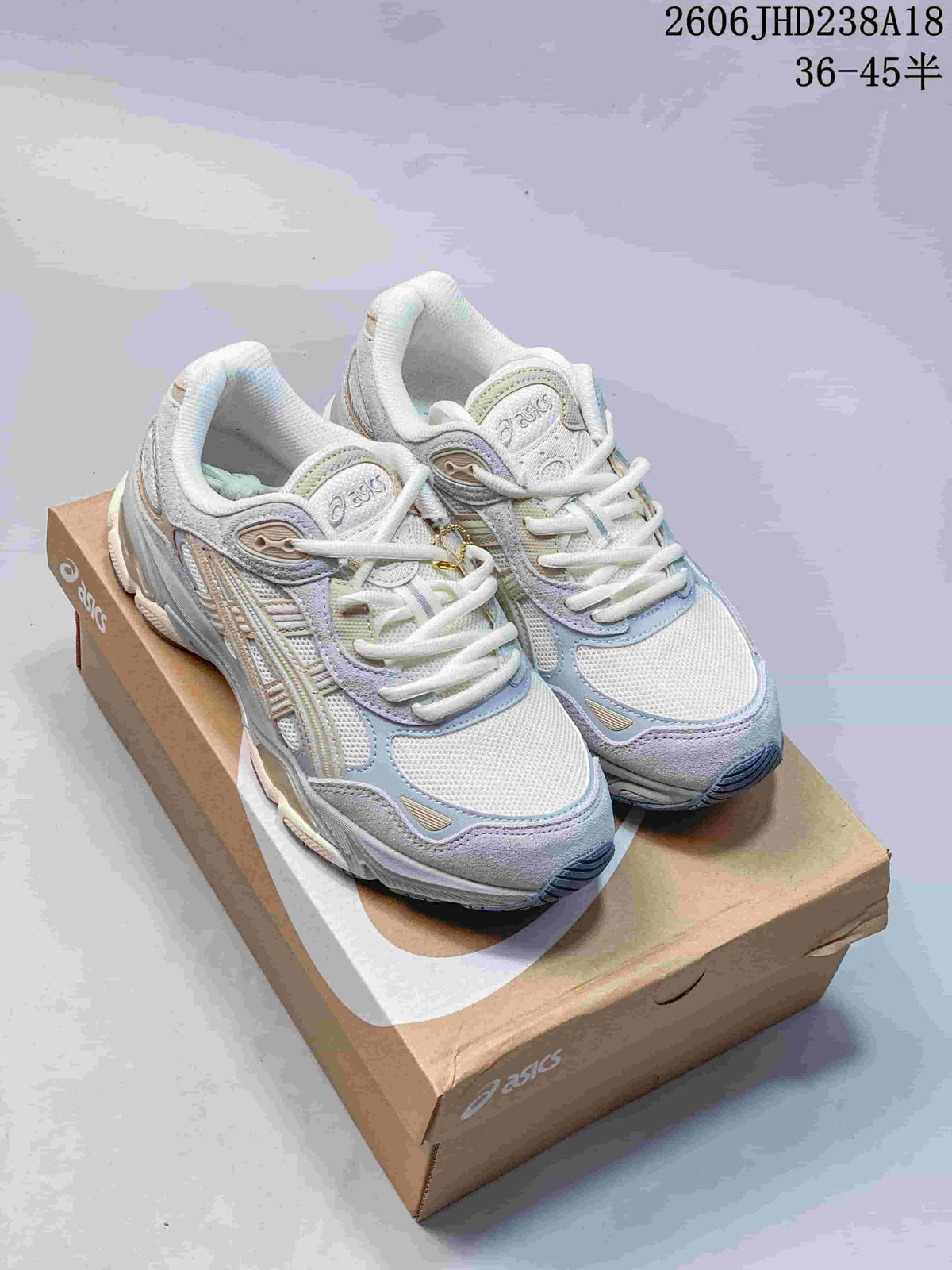 Pair of white sneakers with pastel blue, lavender, and beige details