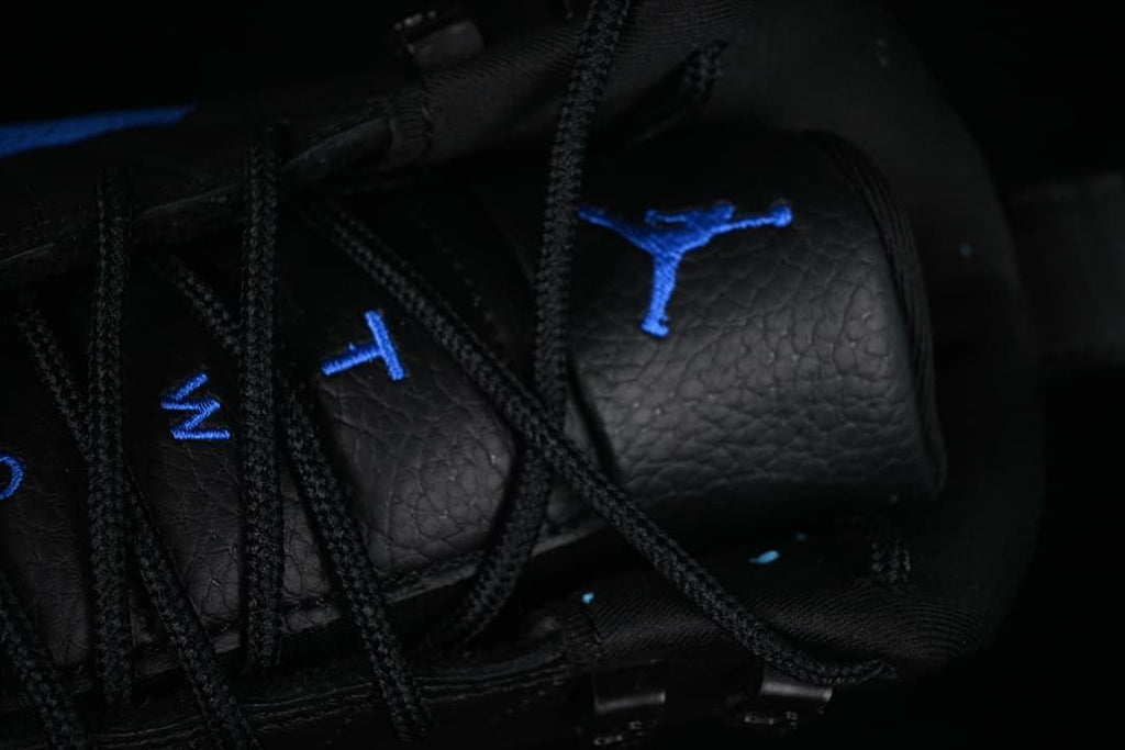 Close-up of black laces and blue tongue embroidery