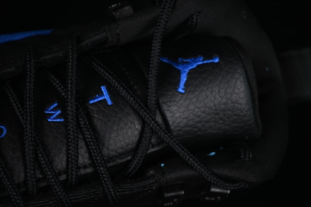 Close-up of black laces and blue tongue embroidery