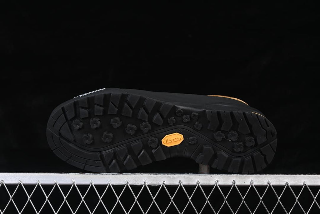 Underside view of the lugged outsole with Vibram mark