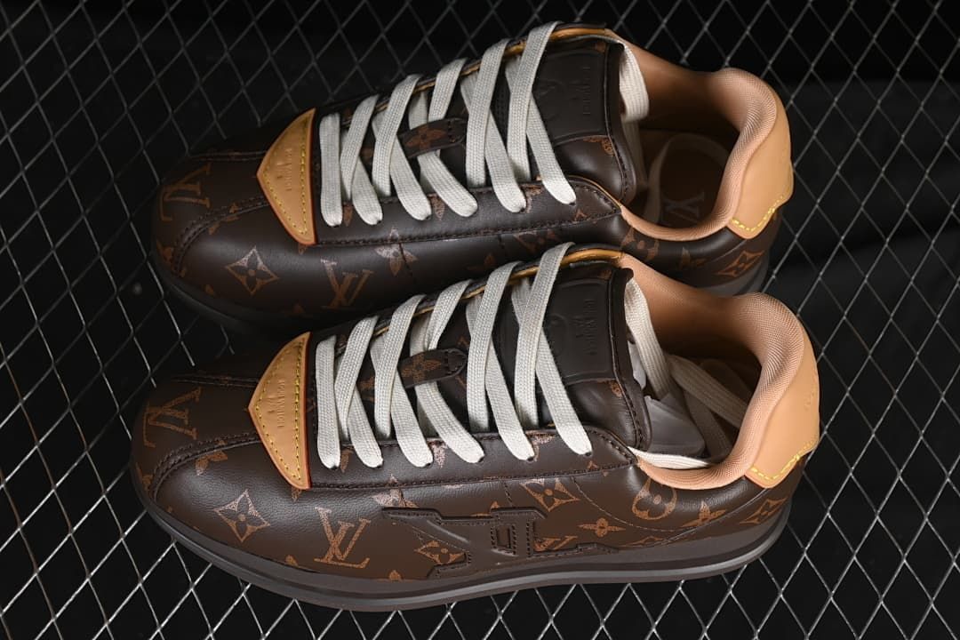 Pair of dark brown patterned low-top sneakers with cream laces.