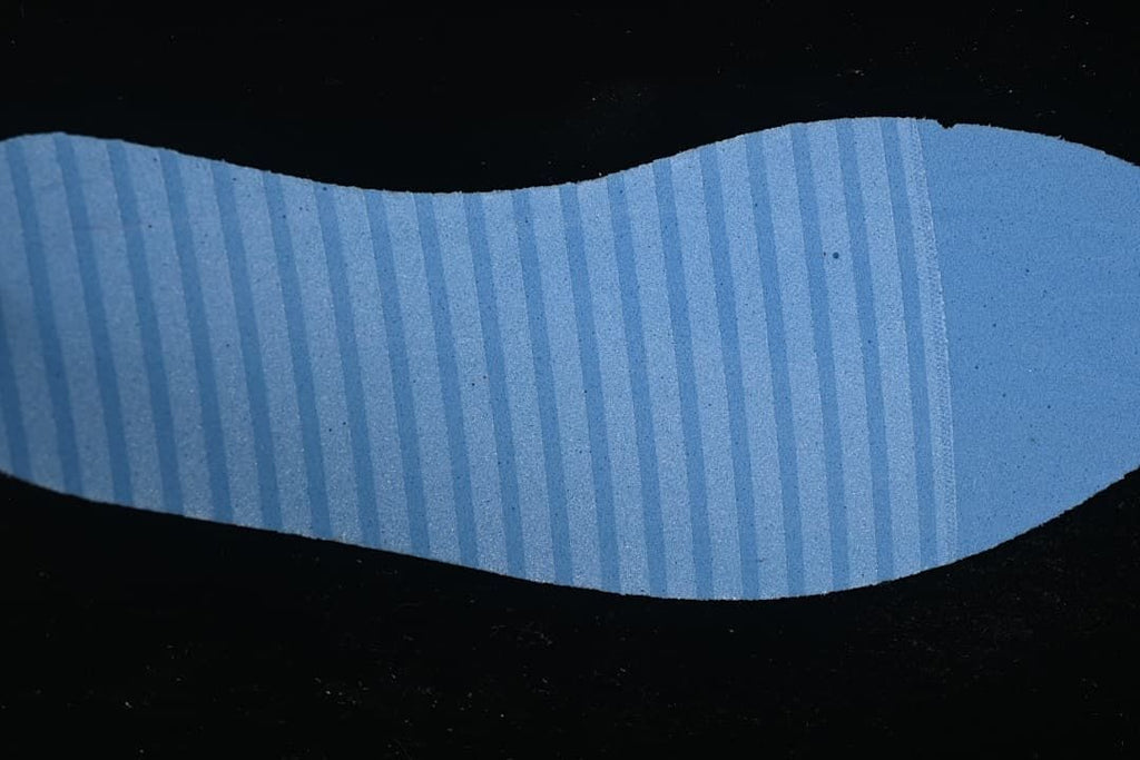 Close-up of a blue-toned textured outsole surface.