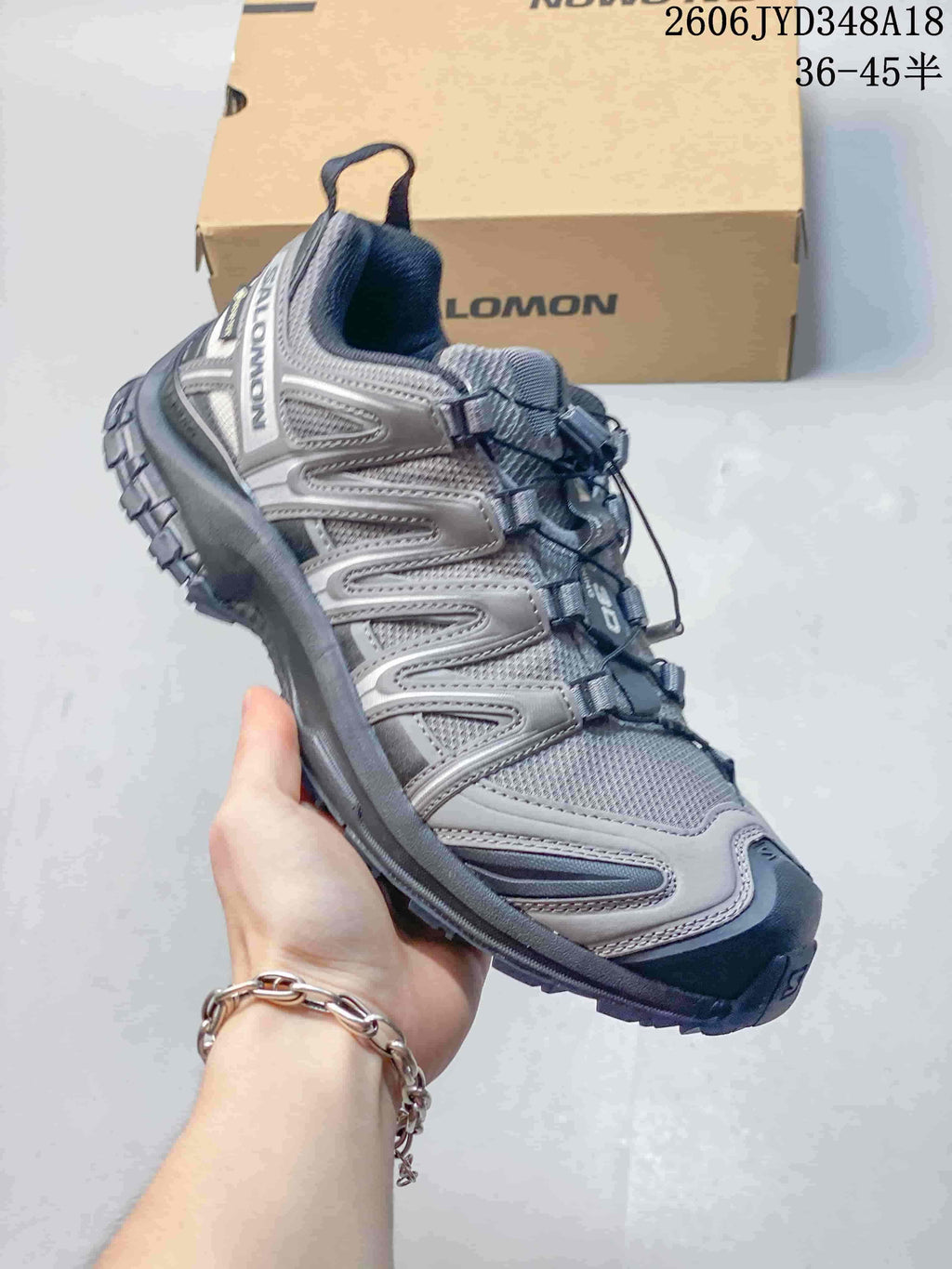 Close-up side view of a gray Salomon XT-3D shoe.