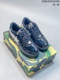 Navy glossy BAPE STA low-top sneakers on a camouflage-patterned box