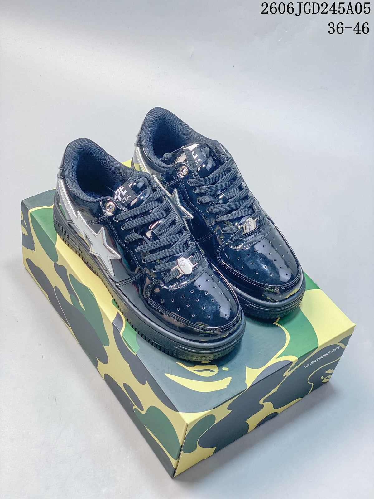 Navy glossy BAPE STA low-top sneakers on a camouflage-patterned box