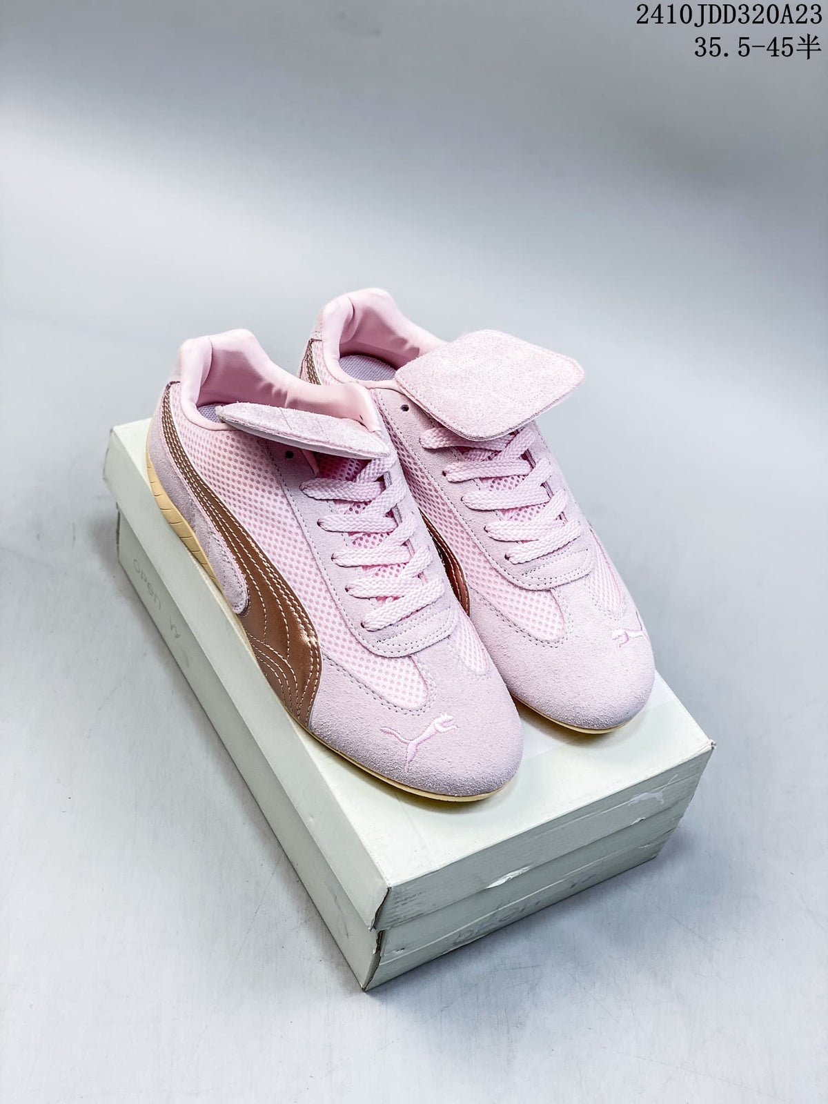 Pair of pale pink Puma Speedcat sneakers with bronze side stripes and removable tongue flaps