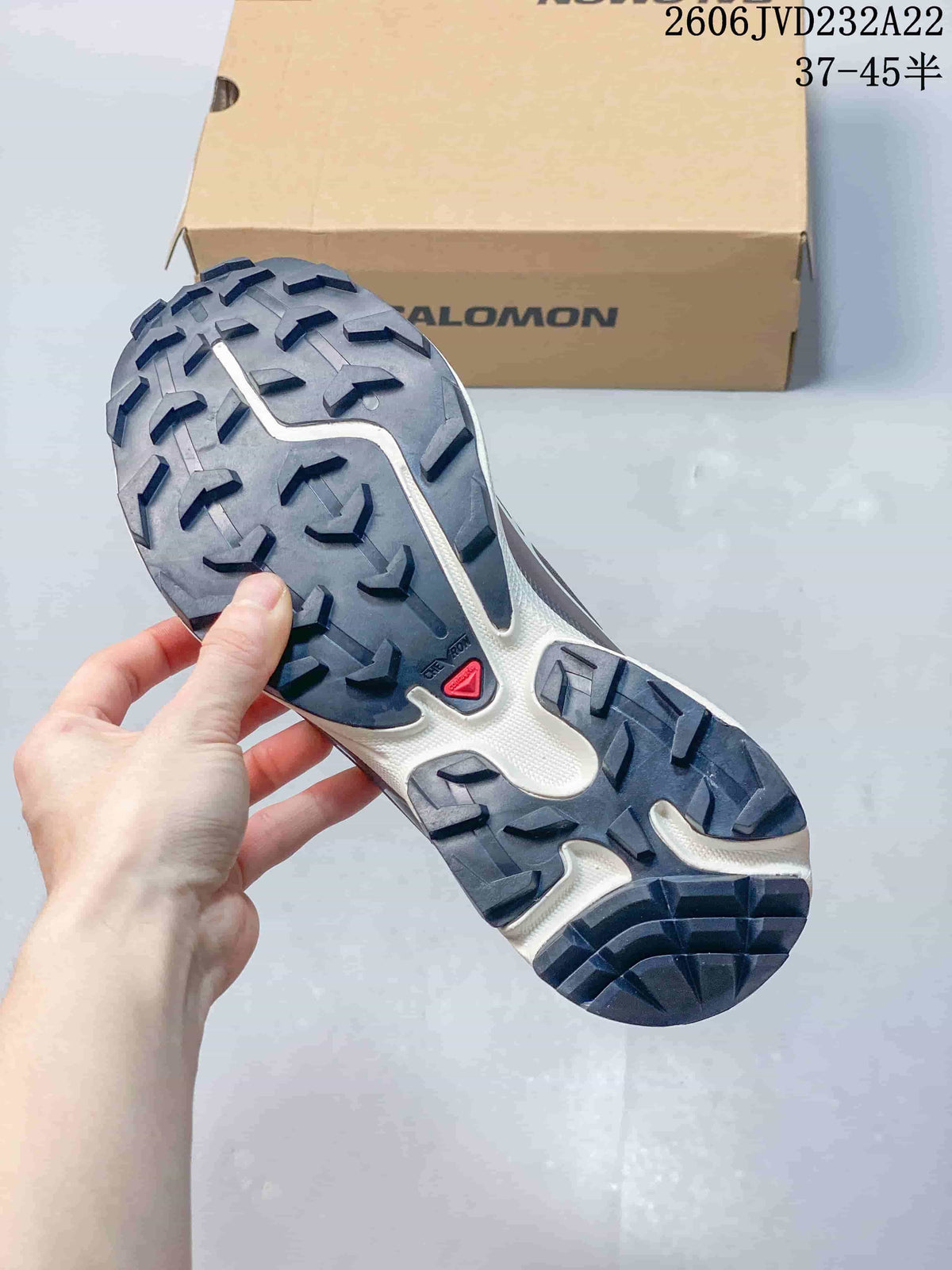 Close-up of the lugged outsole on a Salomon XT-6 shoe.