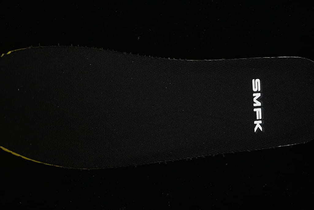 Close-up of a black shoe insert marked SMFK.